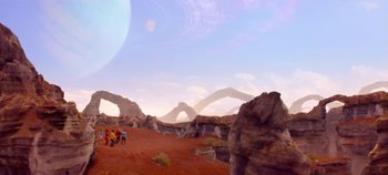 Movie still from “Black Mirror” (2011), created by Charlie Brooker – A group of people walking on a dirt field; Extreme Wide shot, High angle