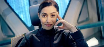 Movie still from “Black Mirror” (2011), created by Charlie Brooker – A woman sitting in a car with her hand to her head; Close Up shot, Over the shoulder angle