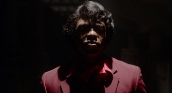 Movie still from “Get on Up” (2014), directed by Tate Taylor – A man wearing a red suit and a red tie; Close Up shot, Low angle