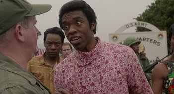 Movie still from “Get on Up” (2014), directed by Tate Taylor – A man in a floral shirt standing in front of a crowd; Close Up shot, Over the shoulder angle