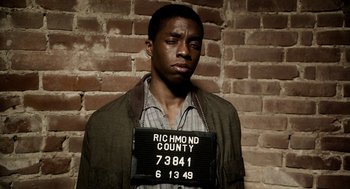 Movie still from “Get on Up” (2014), directed by Tate Taylor – A man in a brown jacket and a brown jacket; Close Up shot, Low angle