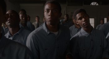 Movie still from “Get on Up” (2014), directed by Tate Taylor – A group of young men standing next to each other in a room; Medium shot, Low angle
