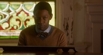Movie still from “Get on Up” (2014), directed by Tate Taylor – A man sitting in front of a computer monitor; Close Up shot, Over the shoulder angle