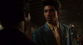 Movie still from “Get on Up” (2014), directed by Tate Taylor – A man wearing a suit and tie talking to another man; Close Up shot, Over the shoulder angle