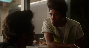 Movie still from “Get on Up” (2014), directed by Tate Taylor – A man sitting in front of another man in front of a table; Close Up shot, Over the shoulder angle