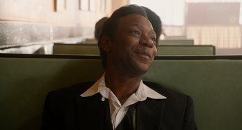 Movie still from “Get on Up” (2014), directed by Tate Taylor – A man sitting on a bench looking up at the sky; Close Up shot, Over the shoulder angle