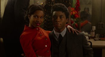 Movie still from “Get on Up” (2014), directed by Tate Taylor – A man and a woman posing for a picture; Medium shot, Low angle