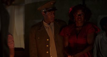 Movie still from “Get on Up” (2014), directed by Tate Taylor – A man and a woman dressed in military uniforms; Medium shot, Low angle
