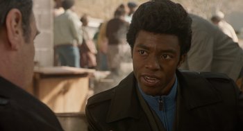 Movie still from “Get on Up” (2014), directed by Tate Taylor – A person wearing a jacket; Close Up shot, Over the shoulder angle