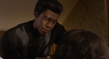 Movie still from “Get on Up” (2014), directed by Tate Taylor – A young man looking at a woman in a room; Close Up shot, Over the shoulder angle