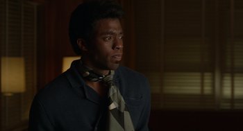 Movie still from “Get on Up” (2014), directed by Tate Taylor – A man wearing a suit and a neck tie; Close Up shot, Over the shoulder angle