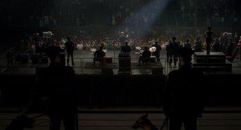 Movie still from “Get on Up” (2014), directed by Tate Taylor – A group of men playing drums in front of an audience; Extreme Wide shot, High angle