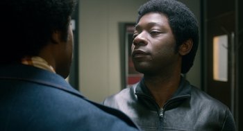 Movie still from “Get on Up” (2014), directed by Tate Taylor – A man looking at his reflection in a mirror; Close Up shot, Over the shoulder angle