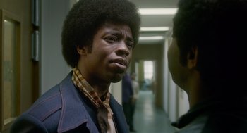 Movie still from “Get on Up” (2014), directed by Tate Taylor – A black man with a black afro is looking at another black man; Close Up shot, Over the shoulder angle