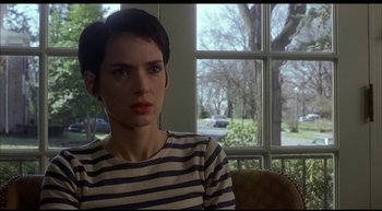 Movie still from “Girl, Interrupted” (1999), directed by James Mangold – A woman sitting in front of a window looking sad; Close Up shot, Over the shoulder angle