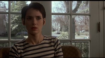 Movie still from “Girl, Interrupted” (1999), directed by James Mangold – A woman sitting in front of a window looking sad; Close Up shot, Over the shoulder angle
