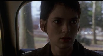 Movie still from “Girl, Interrupted” (1999), directed by James Mangold – A young woman with short black hair looking at the camera; Close Up shot, Low angle