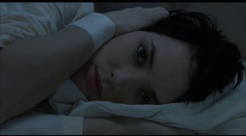 Movie still from “Girl, Interrupted” (1999), directed by James Mangold – A woman laying in a bed with her head on a pillow; Close Up shot, Overhead angle