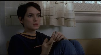 Movie still from “Girl, Interrupted” (1999), directed by James Mangold – A woman sitting on the floor holding a pencil; Close Up shot, High angle