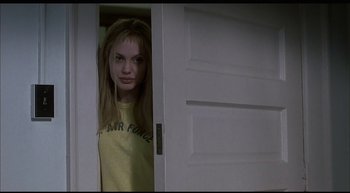 Movie still from “Girl, Interrupted” (1999), directed by James Mangold – A woman standing in front of an open door; Medium shot, Low angle