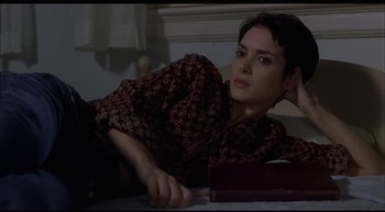 Movie still from “Girl, Interrupted” (1999), directed by James Mangold – A woman sitting at a table with a book in front of her; Medium shot, High angle