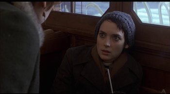 Movie still from “Girl, Interrupted” (1999), directed by James Mangold – A woman wearing a coat and a hat looking into the camera; Close Up shot, Over the shoulder angle