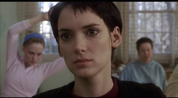 Movie still from “Girl, Interrupted” (1999), directed by James Mangold – A person with short black hair; Close Up shot, Over the shoulder angle