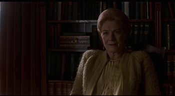 Movie still from “Girl, Interrupted” (1999), directed by James Mangold – An older woman standing in front of bookshelves; Close Up shot, Low angle