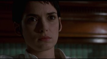 Movie still from “Girl, Interrupted” (1999), directed by James Mangold – A person with short black hair; Close Up shot, Low angle