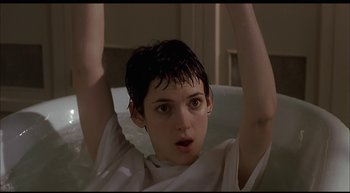 Movie still from “Girl, Interrupted” (1999), directed by James Mangold – A young woman with short black hair holding her arms up; Close Up shot, Low angle