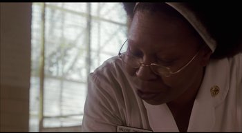 Movie still from “Girl, Interrupted” (1999), directed by James Mangold – An older woman wearing glasses and a white robe; Close Up shot, Low angle