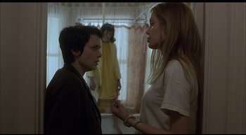 Movie still from “Girl, Interrupted” (1999), directed by James Mangold – Two young women are talking to each other in a room; Medium shot, Over the shoulder angle