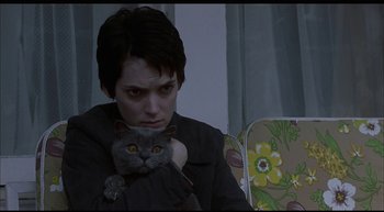 Movie still from “Girl, Interrupted” (1999), directed by James Mangold – A woman holding a cat in her arms; Close Up shot, Low angle