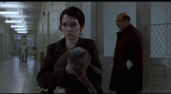 Movie still from “Girl, Interrupted” (1999), directed by James Mangold – A woman holding a cat in her arms in front of a man; Medium shot, Over the shoulder angle