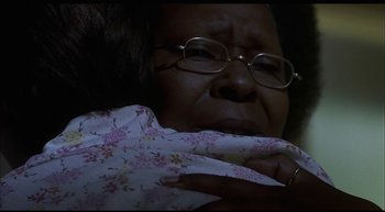 Movie still from “Girl, Interrupted” (1999), directed by James Mangold – An older woman wearing glasses and holding a baby; Close Up shot, Over the shoulder angle