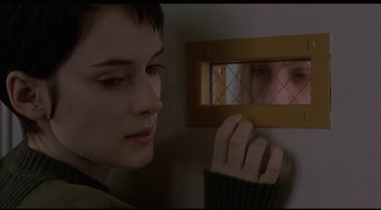 Movie still from “Girl, Interrupted” (1999), directed by James Mangold – A woman looking at her reflection in a mirror; Close Up shot, Over the shoulder angle