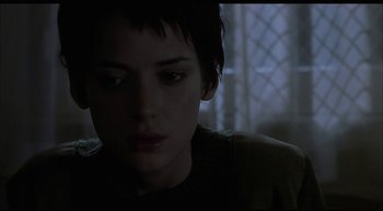 Movie still from “Girl, Interrupted” (1999), directed by James Mangold – A young woman with short black hair looking at the camera; Close Up shot, Low angle