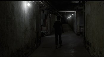 Movie still from “Girl, Interrupted” (1999), directed by James Mangold – A person is walking in a dark alley way; Wide shot, High angle
