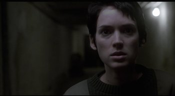 Movie still from “Girl, Interrupted” (1999), directed by James Mangold – A woman with short black hair is looking at the camera; Close Up shot, Over the shoulder angle