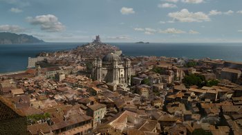 Movie still from “Game of Thrones” (2011), created by D.B. Weiss – An aerial view of an old town with a church; Extreme Wide shot, High angle