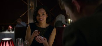 Movie still from “Black Mirror” (2011), created by Charlie Brooker – A woman is smiling while holding a cell phone in her hand; Close Up shot, Over the shoulder angle