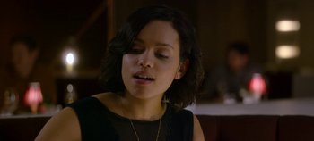 Movie still from “Black Mirror” (2011), created by Charlie Brooker – A person wearing a necklace; Close Up shot, Over the shoulder angle