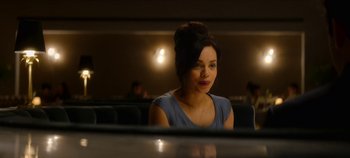 Movie still from “Black Mirror” (2011), created by Charlie Brooker – A woman sitting at a table in front of a mirror; Medium shot, Over the shoulder angle