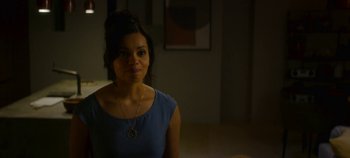 Movie still from “Black Mirror” (2011), created by Charlie Brooker – A woman in a blue shirt is standing in a room; Close Up shot, Over the shoulder angle