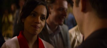 Movie still from “Black Mirror” (2011), created by Charlie Brooker – A group of people standing next to each other in a room; Close Up shot, Over the shoulder angle