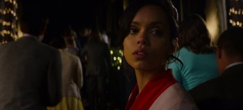 Movie still from “Black Mirror” (2011), created by Charlie Brooker – A woman in a red and white jacket looking at the camera; Close Up shot, Over the shoulder angle