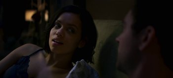 Movie still from “Black Mirror” (2011), created by Charlie Brooker – A woman sitting next to a man on a couch; Close Up shot, Over the shoulder angle