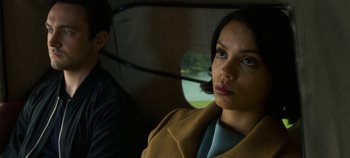 Movie still from “Black Mirror” (2011), created by Charlie Brooker – A man and a woman sitting next to each other in a car; Close Up shot, Low angle