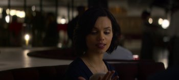 Movie still from “Black Mirror” (2011), created by Charlie Brooker – A woman is looking at her cell phone in a restaurant; Close Up shot, Over the shoulder angle