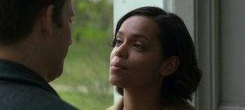 Movie still from “Black Mirror” (2011), created by Charlie Brooker – A woman looking at a man in a yellow jacket; Close Up shot, Over the shoulder angle